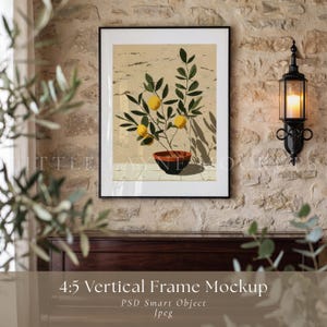 May include: A framed art print featuring a botanical illustration of a lemon tree in a terracotta pot. The artwork has a neutral color palette with a black frame. The print is displayed against a textured stone wall.