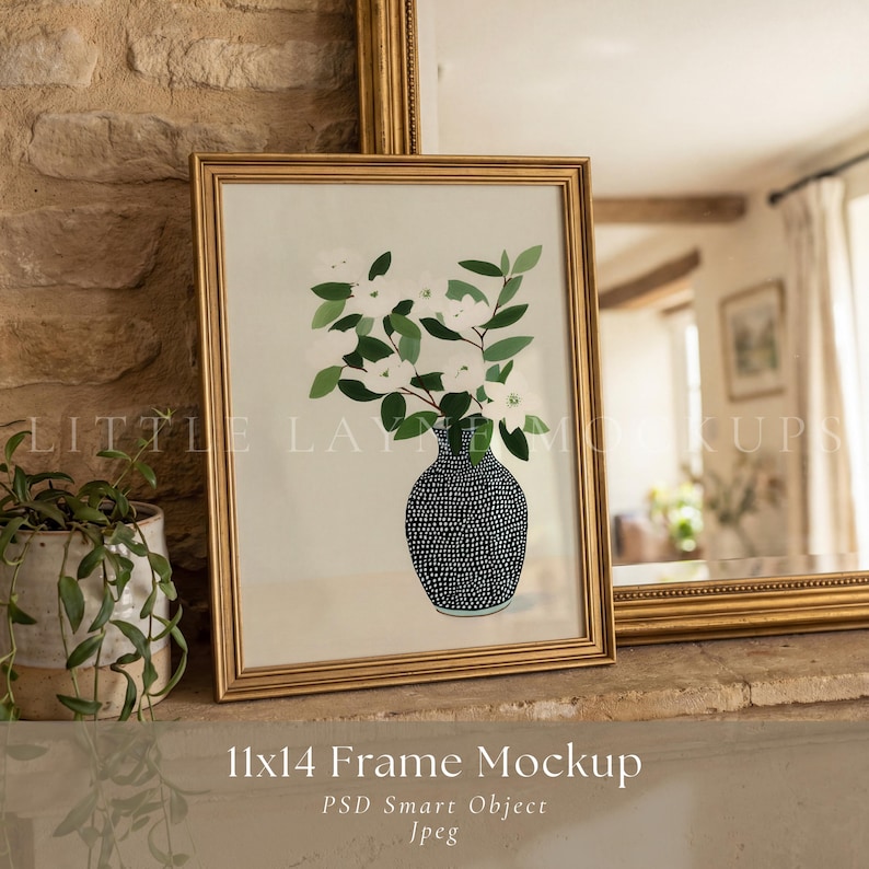 May include: A framed 11x14 inch mockup featuring a gold frame with a floral illustration. The artwork depicts white flowers and green leaves in a black and white dotted vase. The frame is displayed on a stone surface.