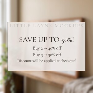 May include: A white rectangular sign with the text "LITTLE LAYNE MOCKUPS" at the top. The sign says "SAVE UP TO 50%!" with details on discounts for buying multiple items. The background is a blurred interior.