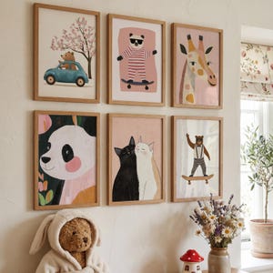 May include: A collection of six framed art prints featuring whimsical animal illustrations. The prints include a bear driving a blue car, a panda, a giraffe, two cats, and a bear on a skateboard. The frames are made of light-colored wood.