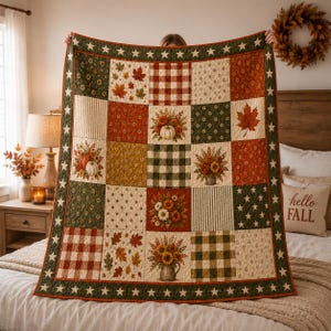 May include: A patchwork quilt featuring a variety of autumn-themed fabric squares, including patterns of pumpkins, sunflowers, maple leaves, and plaid designs in shades of orange, green, and cream, bordered by a dark green trim with white stars.