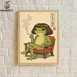 May include: Framed art print featuring a cartoon frog with a bob haircut, smoking a cigarette while seated in a red armchair. The frog is green with brown hair and is set against a beige background. Japanese text is visible in the upper right corner.
