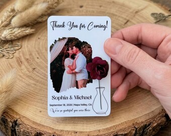 May include: A rectangular white card featuring the text Thank You for Coming! at the top, a photograph of a couple, the names Sophia & Michael, the date September 18, 2026, location Napa Valley, CA, and a dark red paper flower attached to a vase drawing.