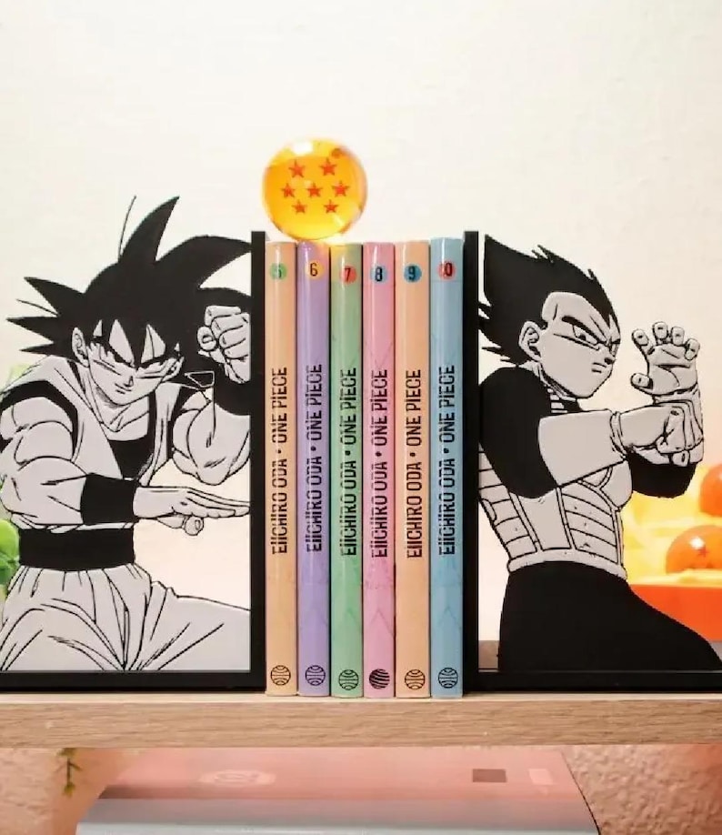 May include: A collection of One Piece manga volumes, numbers 6 to 10, held between Goku and Vegeta character bookends. A clear sphere with stars sits above the books. The book spines are pastel colours.