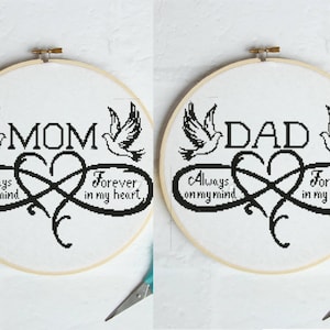 May include: Two cross-stitch embroidery hoops. One says "MOM" with doves and an infinity heart, the text reads "Always on my mind, Forever in my heart." The other says "DAD" with the same design.