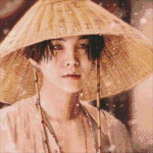 May include: A portrait of a person with dark hair wearing a wide-brimmed, woven straw conical hat. The individual has a neutral expression, dark eyes, and is dressed in a light-colored, textured garment. The image has a pixelated, mosaic-like appearance.