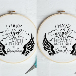 May include: A cross-stitch embroidery hoop with the text "I HAVE AN angel IN HEAVEN AND I CALL HER Grandma" in black thread. The design includes black angel wings and cloud-like shapes.
