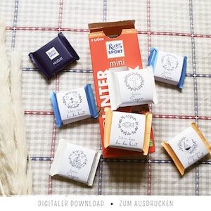 May include: An assortment of Ritter Sport Mini chocolate bars and individually wrapped candies with religious symbols and text. The chocolate bars are in a red box. The candies have blue, white, and yellow wrappers.