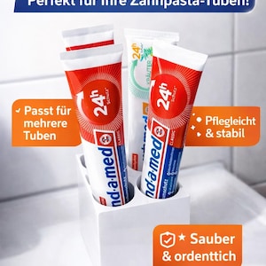 Könnte beinhalten: Ein weißer Zahnbürstenhalter mit drei Zahnpastatuben. Die Tuben sind rot und weiß mit blauen Akzenten. Auf den Tuben steht "24h Schutz" und "nd-a-med CLASSIC". Der Halter steht auf einer weißen Oberfläche.