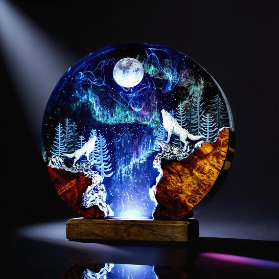 A hand-poured wood-and-epoxy lamp encasing a full aurora-lit wolf forest scene — it's basically a glowing diorama painting trapped in resin.