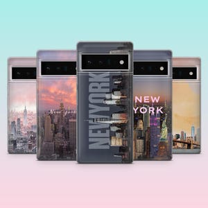 May include: Five phone cases with New York City skyline designs. Each case features a different cityscape image, including the Statue of Liberty, the Brooklyn Bridge, and the city skyline. The cases have a clear border and the words "NEW YORK" are printed on some of the cases.