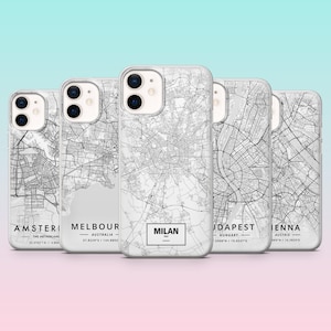 May include: A collection of white phone cases featuring detailed black and white city map designs. Each case is labeled with a city name, including Amsterdam, Melbourne, Milan, Budapest, and Vienna. The cases have a gradient background.