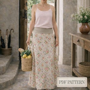 Könnte beinhalten: Langer Blumenrock mit beigem Hintergrund und rosa Blumen. Der Rock wird mit einem hellrosa Trägertop kombiniert. Ein Weidenkorb mit Zitronen und Brot wird getragen. Das Bild enthält den Text "PDF PATTERN".