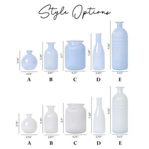May include: Collection of glass vases in various shapes and sizes, including round, cylindrical, and bottle-shaped designs. The vases are available in both light blue and white, with heights ranging from 3.74 inches to 9.56 inches.