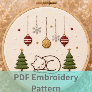 May include: Embroidered Christmas design in a wooden hoop. The design features a sleeping cat, Christmas trees, ornaments, snowflakes, and stars. The text "PDF Embroidery Pattern" is at the bottom.