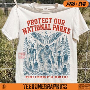 May include: A cream-colored short-sleeve t-shirt featuring a red and blue graphic print. The text reads PROTECT OUR NATIONAL PARKS and WHERE LEGENDS STILL ROAM FREE. The illustration depicts a moth, a deer, Bigfoot, an alien, and ghosts.