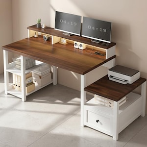 May include: A modern two-tone computer desk with a dark brown desktop and white legs and shelving. The desk has a raised monitor shelf with two computer monitors, a printer, and a side table with a drawer. The desk has a storage shelf with baskets and boxes.
