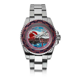 May include: A stainless steel wristwatch with a pink and blue face featuring a Japanese landscape design. The watch has a silver strap and a rotating bezel with city names. The face depicts Mount Fuji, a red sun, and cherry blossoms.
