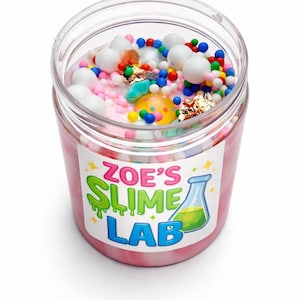 May include: A clear plastic jar filled with pink slime and colorful decorations. The slime is topped with white, pink, and colorful beads, along with gold foil and a yellow and orange object. The jar has a label that reads "Zoe's Slime Lab."
