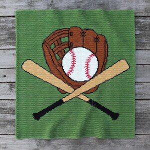 May include: A green crocheted blanket featuring a baseball theme. The design includes a brown baseball glove, a white baseball with red stitching, and two crossed baseball bats with black handles. The blanket is square.