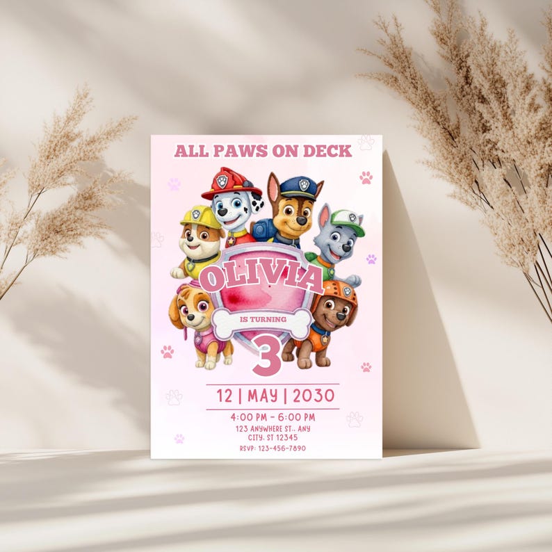 May include: Pink birthday party invitation featuring the Paw Patrol characters. The invitation includes the text "ALL PAWS ON DECK" and "OLIVIA IS TURNING 3". Additional details include the date, time, and location of the party.