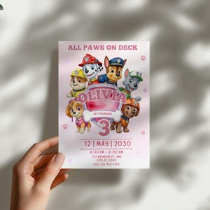 May include: A pink birthday invitation featuring the Paw Patrol characters. The invitation includes the text "ALL PAWS ON DECK" and "OLIVIA IS TURNING 3". The date and time of the party are also included.