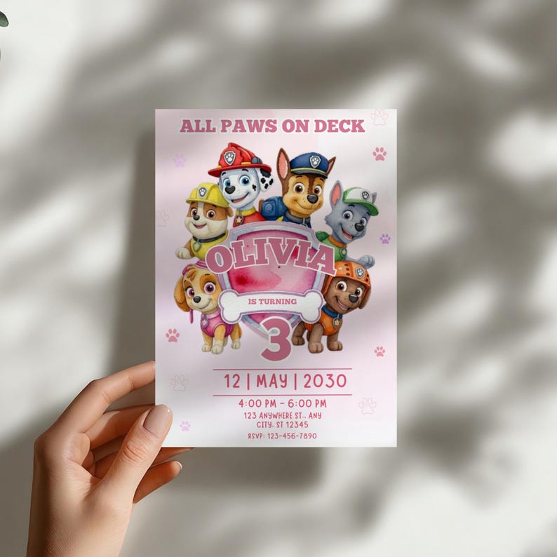 May include: A pink birthday invitation featuring the Paw Patrol characters. The invitation includes the text "ALL PAWS ON DECK" and "OLIVIA IS TURNING 3". The date and time of the party are also included.