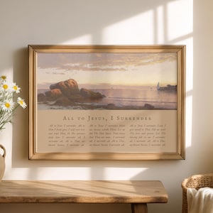 May include: A framed print featuring a serene seascape with a rocky shoreline and a calm ocean under a sunset sky. The print includes the text "ALL TO JESUS, I SURRENDER" and a poem. The frame is a warm, golden color.