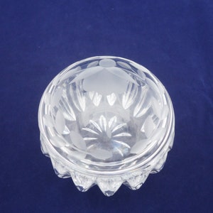 May include: A clear glass bowl with a frosted design. The bowl has a scalloped edge and a round base.