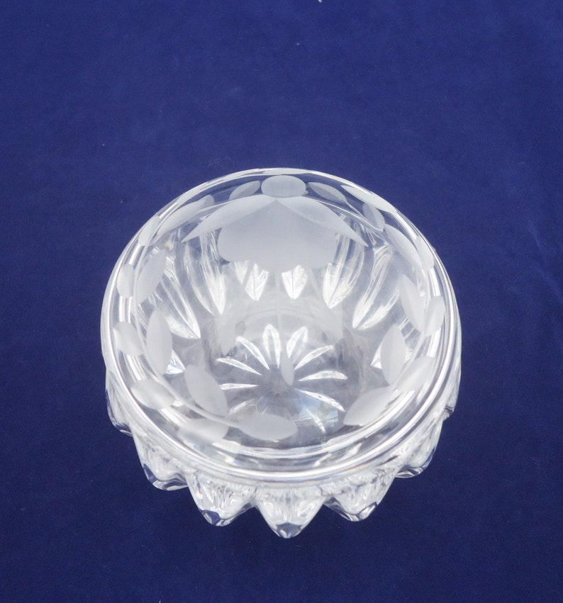 May include: A clear glass bowl with a frosted design. The bowl has a scalloped edge and a round base.