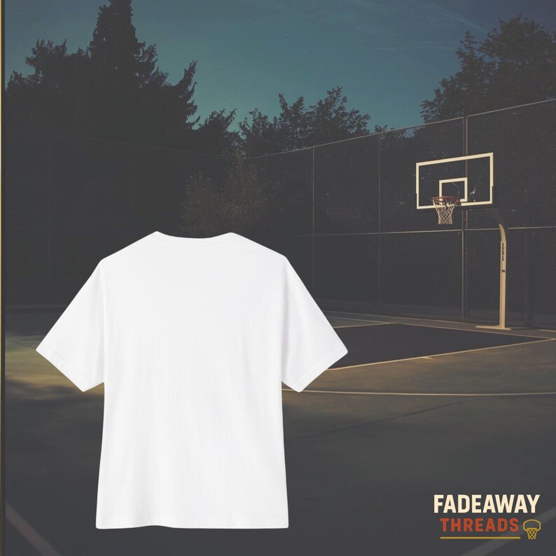 May include: A white t-shirt with short sleeves is centered in front of a basketball court. The court has a hoop and net. The text "FADEAWAY THREADS" is in the lower right corner.