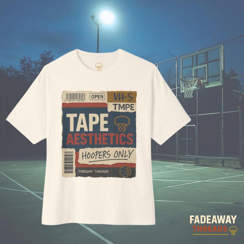 May include: Off-white t-shirt with a graphic design featuring the words "TAPE AESTHETICS HOOPERS ONLY" in a vintage style. The design includes a basketball hoop and a barcode. The shirt is set against a basketball court background.