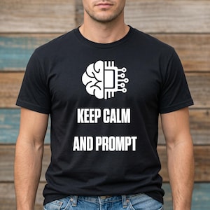 May include: A white ceramic mug with a black handle and the text "But First, Coffee" in a bold, black font. The mug is set against a blurred background. The mug appears to be approximately 10 cm tall.