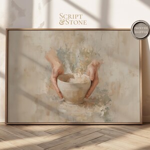 Puede incluir: Una impresión artística enmarcada con una paleta de colores neutros. La obra de arte representa manos sosteniendo un cuenco, con el texto "Script & Stone" y un sello "Printed Shipped". El tema general es una estética vintage y artística.