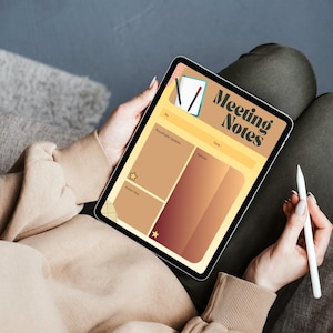 May include: A digital tablet displaying a "Meeting Notes" template. The template features sections for notes, agenda, and dates, with a color scheme of tan, brown, and gold. A stylus rests near the tablet, suggesting note-taking. The tablet is held in a person's lap.
