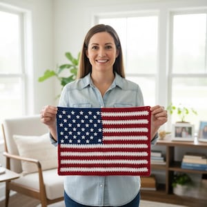 May include: A crocheted American flag with a blue field of white stars and red and white stripes. The flag is rectangular and appears to be handmade. The colors are vibrant and the stitches are clearly visible.