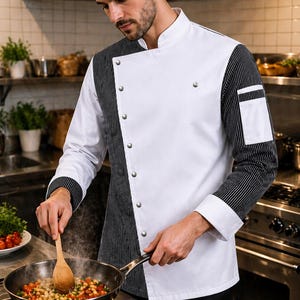 May include: A chef coat featuring a white asymmetrical front panel with silver buttons, contrasted by black and white pinstriped sleeves and a side panel. The garment includes a mandarin collar, white cuffs, and a rectangular pocket on the left sleeve.