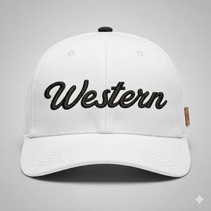 May include: White baseball cap with the word "Western" embroidered in black script across the front. The cap has a curved brim, a small black button on top, and a brown tag on the side.