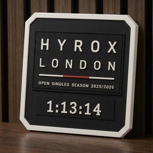 May include: A square black plaque with a white border featuring the white text HYROX LONDON, a horizontal red and white line, and the text OPEN SINGLES SEASON 2025/2026. Below this, the white numbers 1:13:14 are displayed on a black background.
