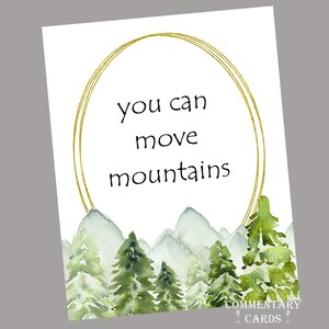 May include: An art print with a watercolour illustration of mountains and trees. The text "you can move mountains" is within a gold oval. The bottom right corner has the text "COMMENTARY CARDS".