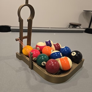 May include: A white ceramic mug with a black handle and the text "But First, Coffee" in a bold, black font. The mug is set against a blurred background, suggesting a cozy setting.