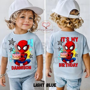 May include: Light blue children's t-shirt featuring a Spider-Man graphic holding a birthday cake. The front of the shirt has the number 4 and the name "DANNISON". The back of the shirt says "IT'S MY BIRTHDAY".