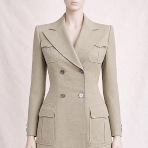 May include: A double-breasted beige blazer featuring a tailored fit, wide lapels, and four front pockets with flaps. The jacket includes two sets of buttons on the front and long sleeves, presented on a mannequin against a neutral background.