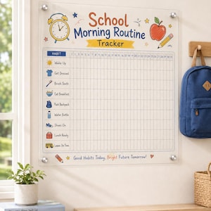 May include: A clear acrylic School Morning Routine Tracker board featuring a grid with 31 columns and rows for daily habits like wake up, get dressed, and brush teeth. The board includes colorful illustrations of an alarm clock, apple, and school bus.