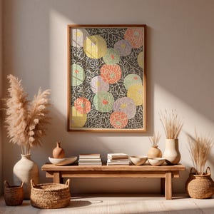 Pode incluir: Uma impressão de arte de parede retangular emoldurada com um fundo cinza escuro, apresentando um padrão repetitivo de contornos de folhas brancas e motivos florais circulares sobrepostos em tons de amarelo, pêssego, lavanda e verde claro.