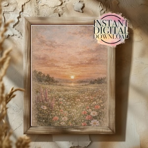 Puede incluir: Una pintura de paisaje enmarcada representa una puesta de sol sobre un campo de flores silvestres. La obra de arte presenta una paleta de colores cálidos con tonos rosas, naranjas y amarillos. El marco es de madera clara. El texto en la imagen dice "INSTANT DIGITAL DOWNLOAD" y "LEGACY INKSTUDIO."