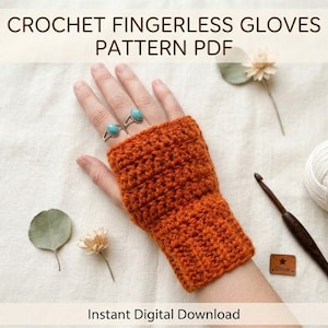 May include: An orange crochet fingerless glove is displayed on a hand, with two turquoise rings. The image includes a crochet hook, a ball of white yarn, and dried flowers. Text at the top reads "CROCHET FINGERLESS GLOVES PATTERN PDF" and "Instant Digital Download" at the bottom.