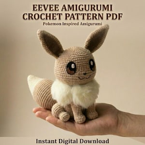 May include: A crocheted Eevee amigurumi, a Pokemon-inspired plushie, is displayed. The plushie is light brown with a cream-colored chest and tail tip. The image includes text that reads "EEVEE AMIGURUMI CROCHET PATTERN PDF" and "Instant Digital Download."