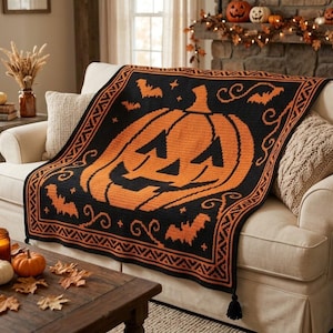 May include: A rectangular crochet throw blanket featuring a large orange jack-o'-lantern centered on a black background, surrounded by orange bat silhouettes and decorative swirls, finished with a geometric border and black corner tassels.