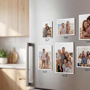 May include: A selection of framed family photographs of different sizes, including 5x7, 6x8, 7x9, 8x11, 9x12, and 10x15 cm, are displayed on a refrigerator. The photos show families and couples in various settings.